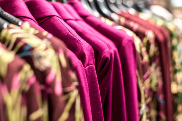 istock colorful clothes hanging on store racks 1129713681