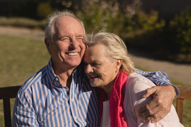 istock Senior couple embracing each other in the park 1129713932
