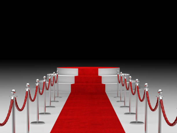 istock Red Carpet Event Amidst Bollards Against Black Background 1129714170