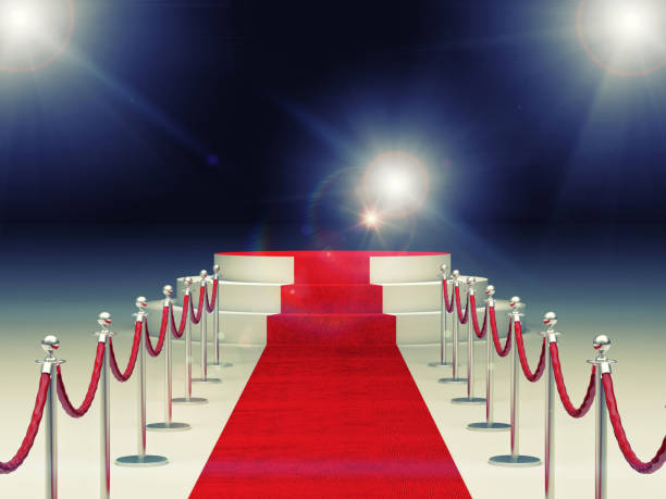 istock Red Carpet Amidst Bollards Against Illuminated Lights 1129714176