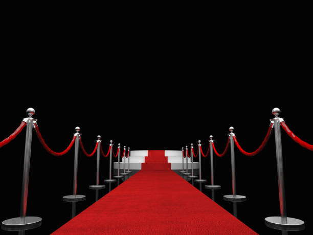 istock Red Carpet Event Amidst Bollards Against Black Background 1129714178