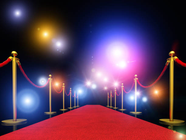 istock Red Carpet Amidst Bollards Against Illuminated Lights 1129714183