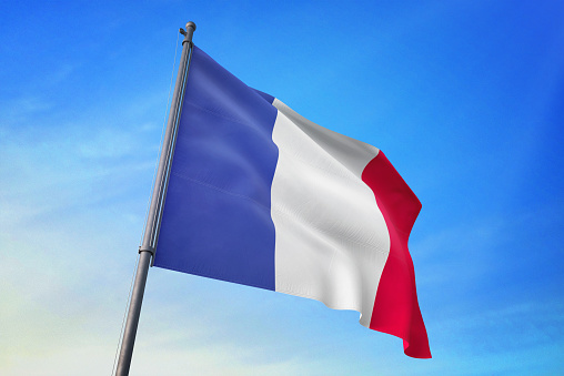 France flag waving in the blue sky in the wind