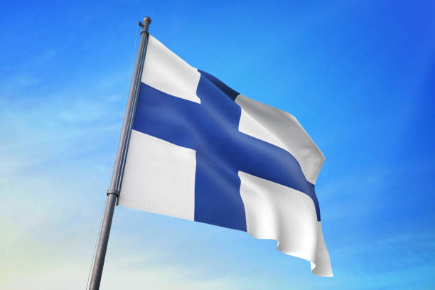 istock Finland flag waving in the blue sky 1129718321