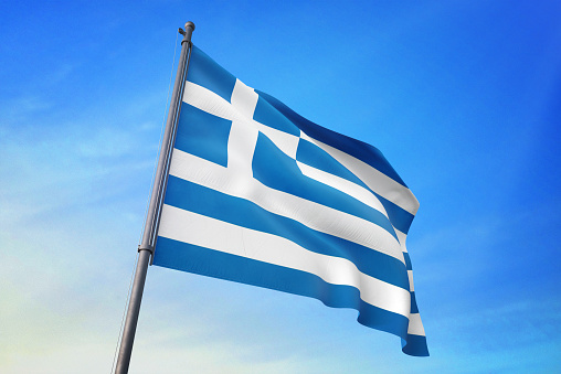 Greece flag waving in the blue sky in the wind