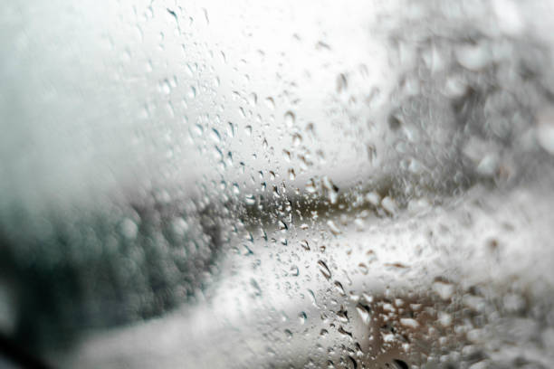 istock View through water drops on a weeping car window on background in winter season 1129718397