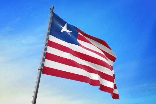 istock Liberia flag waving in the blue sky 1129718617