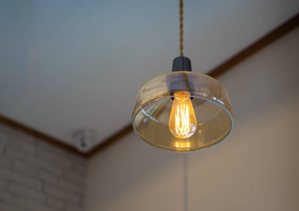 istock Low Angle View Of Illuminated Pendant Light At Home 1129718844