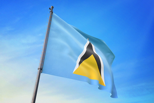 Saint Lucia flag waving in the blue sky in the wind