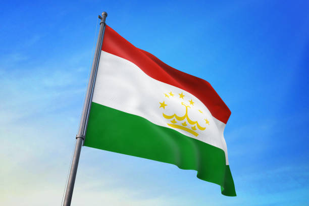 istock Tajikistan flag waving in the blue sky 1129720282