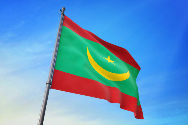 istock Mauritania flag waving in the blue sky 1129720728