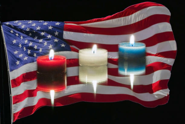 istock USA flag and red white and blue candles on a black background. 1129722906