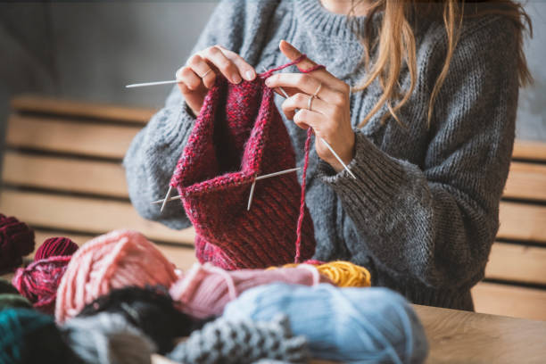 istock Close up on woman's hands knitting 1129725396