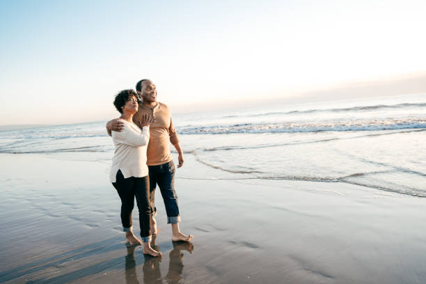 istock Senior couple enjoying sunset on the beach 1129729150