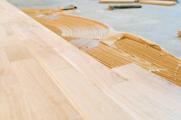 istock Installing new hardwood parquet floor 1129729203