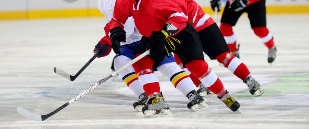 istock Low Section Of People Playing Ice Hockey 1129732319