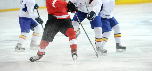 istock Low Section Of People Playing Ice Hockey 1129732320