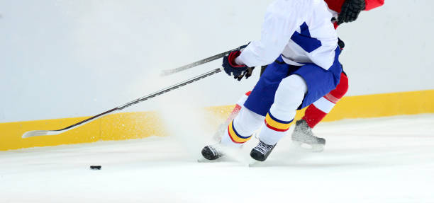 istock Low Section Of People Playing Ice Hockey 1129732323