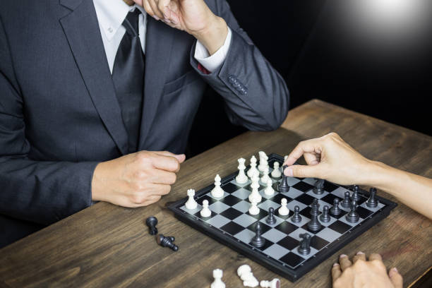 istock High Angle View Of People Playing Chess At Table 1129732969