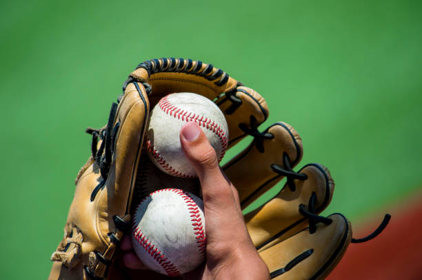 istock Cropped Hand Holding Baseball Ball 1129733591
