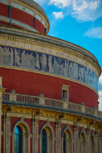 The Royal Albert Hall in London, UK London, UK - May 14 2018: The Royal Albert Hall is a concert hall, opened by  Queen Victoria in 1871 with capacity of up to 5,272 seats and it's one of the UK's most treasured and distinctive buildings royal albert hall stock pictures, royalty-free photos & images