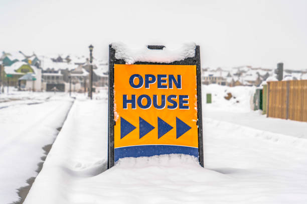 istock Open House sign against snow covered landscape 1129741661