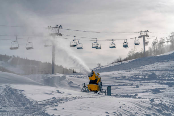 눈 대포와 햇볕에 쬐 인 산 사면에 스키 리프트 - mountain winter season machine snow making machine 뉴스 사진 이미지