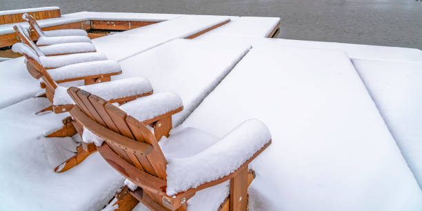 istock Snow covered deck and chairs on a lake in Utah 1129745461