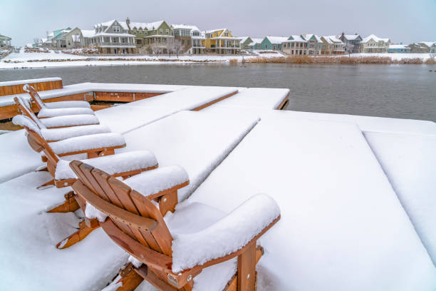istock Snow covered lake deck with chairs in winter 1129745488