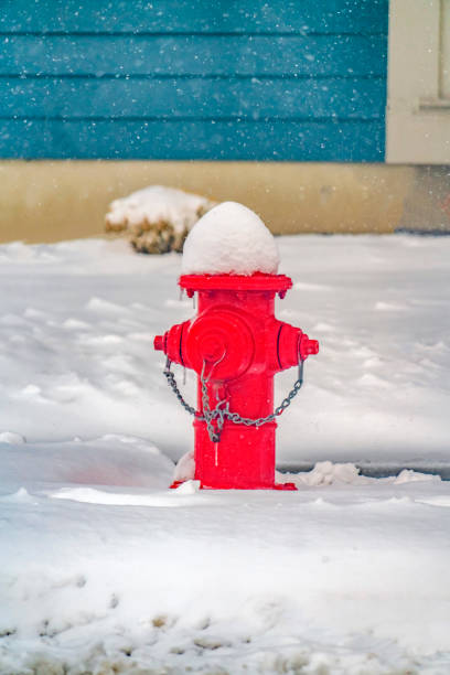 istock Vibrant red fire hydrant against powdery snow 1129745509