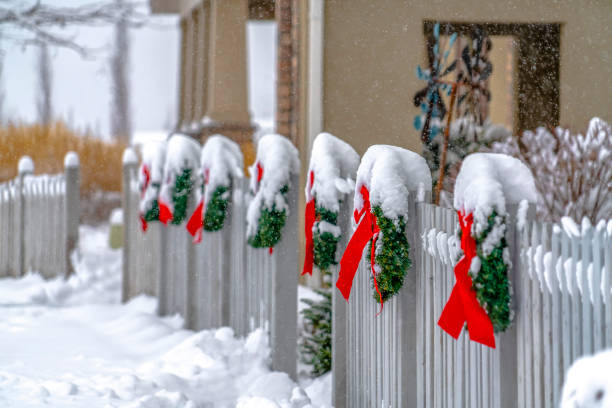 istock White picket fence with wreaths in Daybreak Utah 1129745523