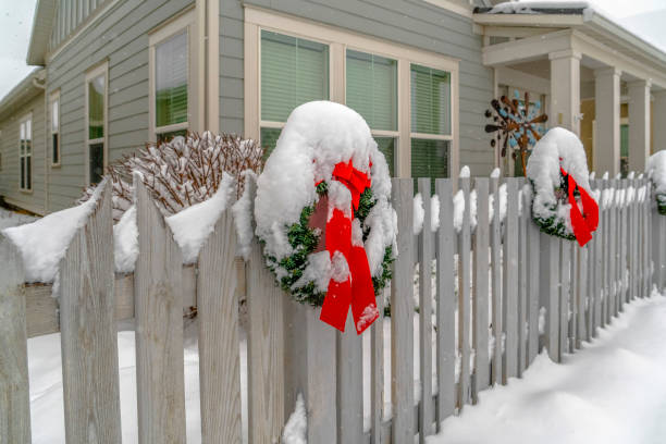 istock Winter landscape with wreath on a picket fence 1129745524
