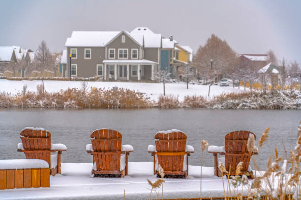 istock Wooden chairs on snowy lake deck in Daybreak Utah 1129745534