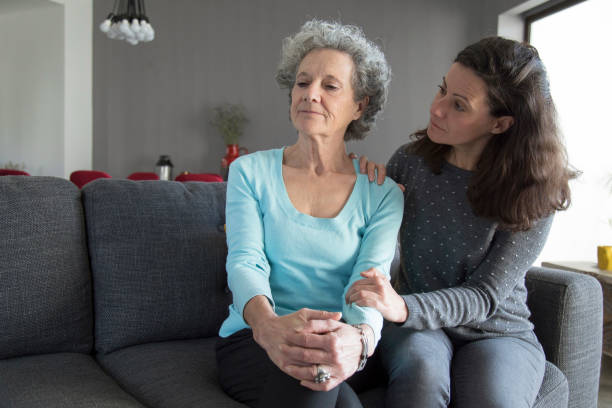 istock Lady holding hand on senior mother shoulder and supporting her 1129748634