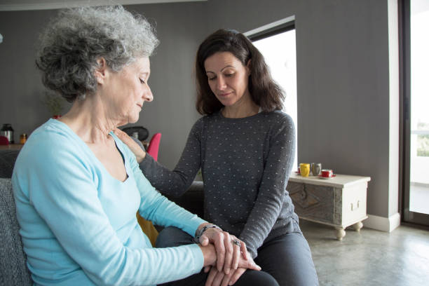 istock Lady holding elderly mother hands and supporting her 1129748652