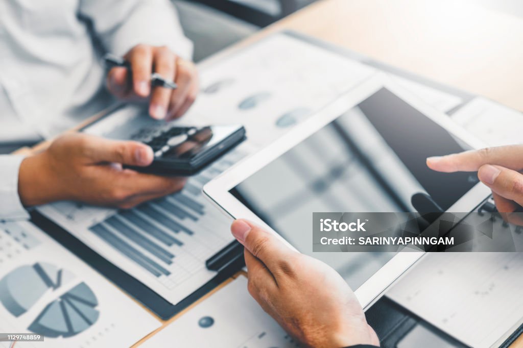 Co-working Business Team Consulting meeting Planning with digital tablet Strategy Analysis investment and saving concept. meeting discussing new plan financial graph data. Financial Loan Stock Photo