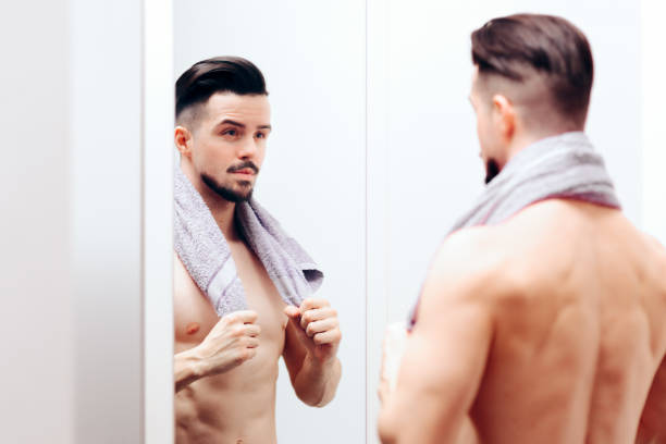 istock Attractive Man Checking Himself in the Mirror 1129752623