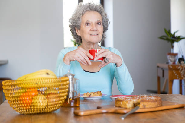 istock Positive senior lady enjoying tasty pie 1129752856