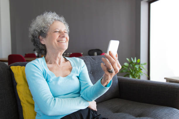 istock Happy senior woman chatting via video call 1129752859
