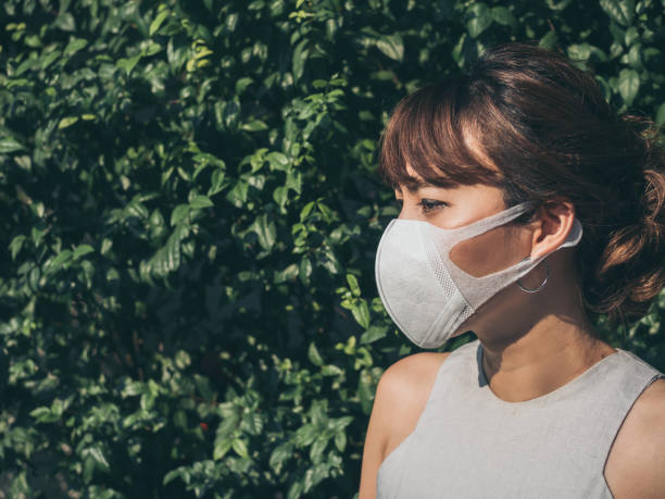 istock Beautiful asian woman wearing white protective N95 mask 1129763320