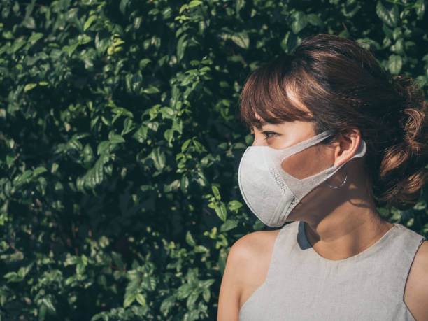 istock Beautiful asian woman wearing white protective N95 mask 1129763321