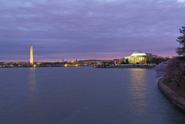 istock City historic monuments with reflection in dark waters at dawn, Washington DC, USA. 1129764252