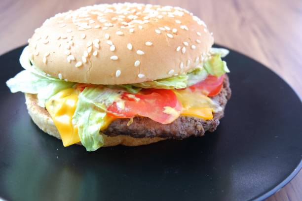 istock Eye level view of full spill delicious burger 1129765014