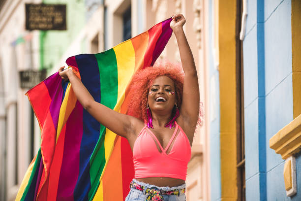 tänzerin mit einer lgbt-fahne - homosexual gay man parade flag stock-fotos und bilder