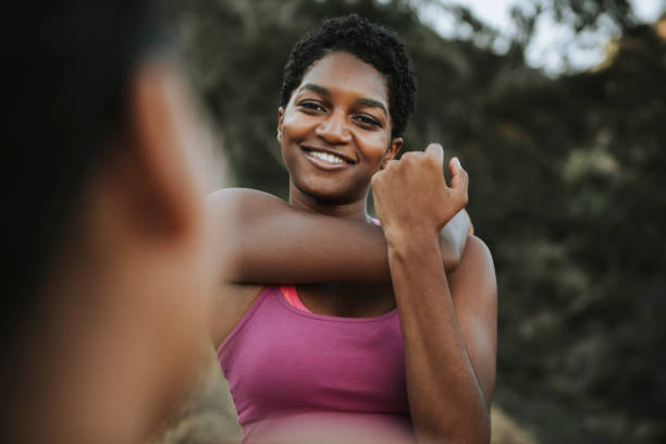 istock Active woman stretching together outdoors 1129769231