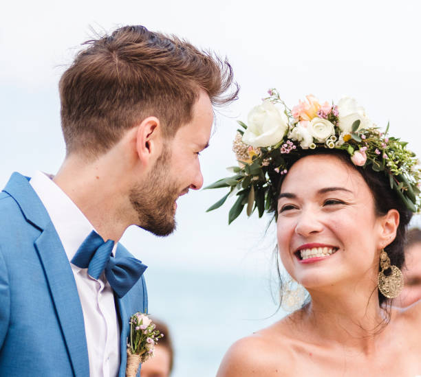 istock Cheerful newlyweds at beach wedding ceremony 1129769968