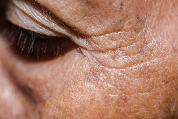 Close-up portrait of beautiful senior woman looking at camera on isolated background