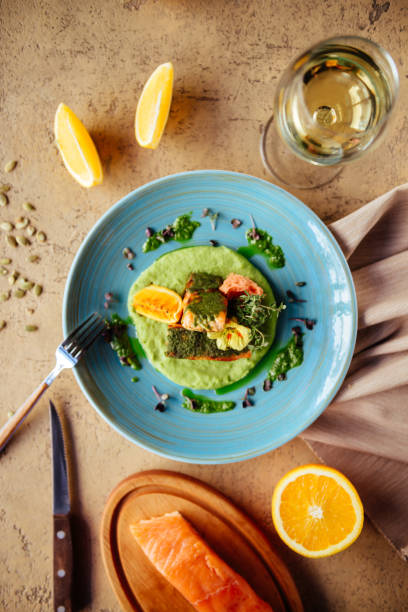 istock Baked salmon garnished with asparagus and tomatoes with herbs. 1129770995
