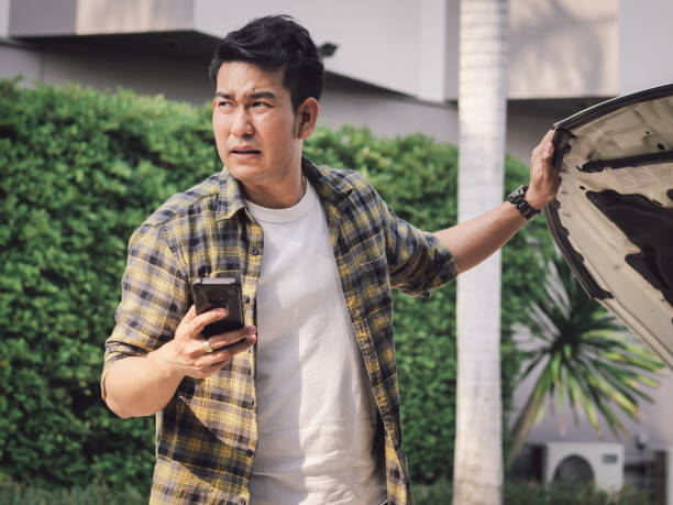istock Asian man is calling a car merchanic and he is very upset for this problem. 1129771115