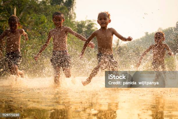 Asia Children On River The Boy Friend Happy Funny Playing Running In The Water In Countryside Of Living Life Kids Farmer Rural People Stock Photo - Download Image Now